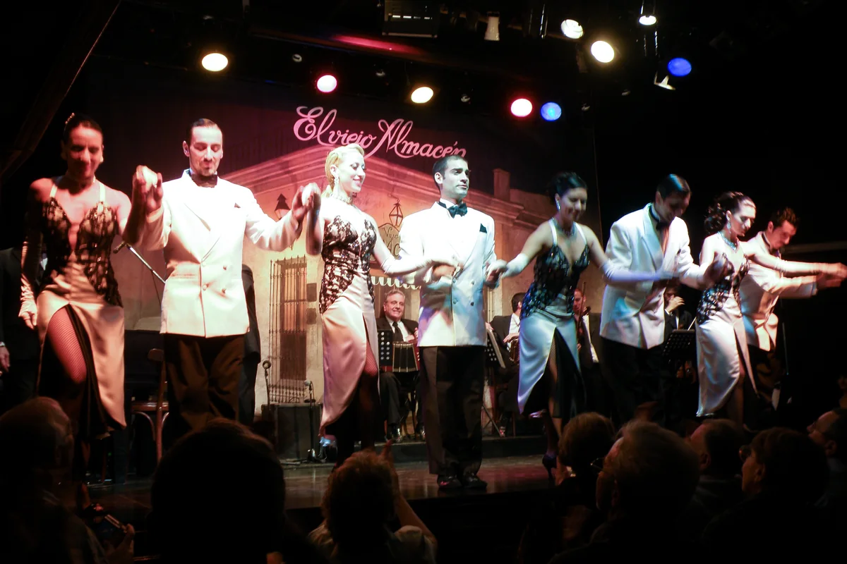 The full company of dancers and singers taking a bow on stage at El Viejo Almacén